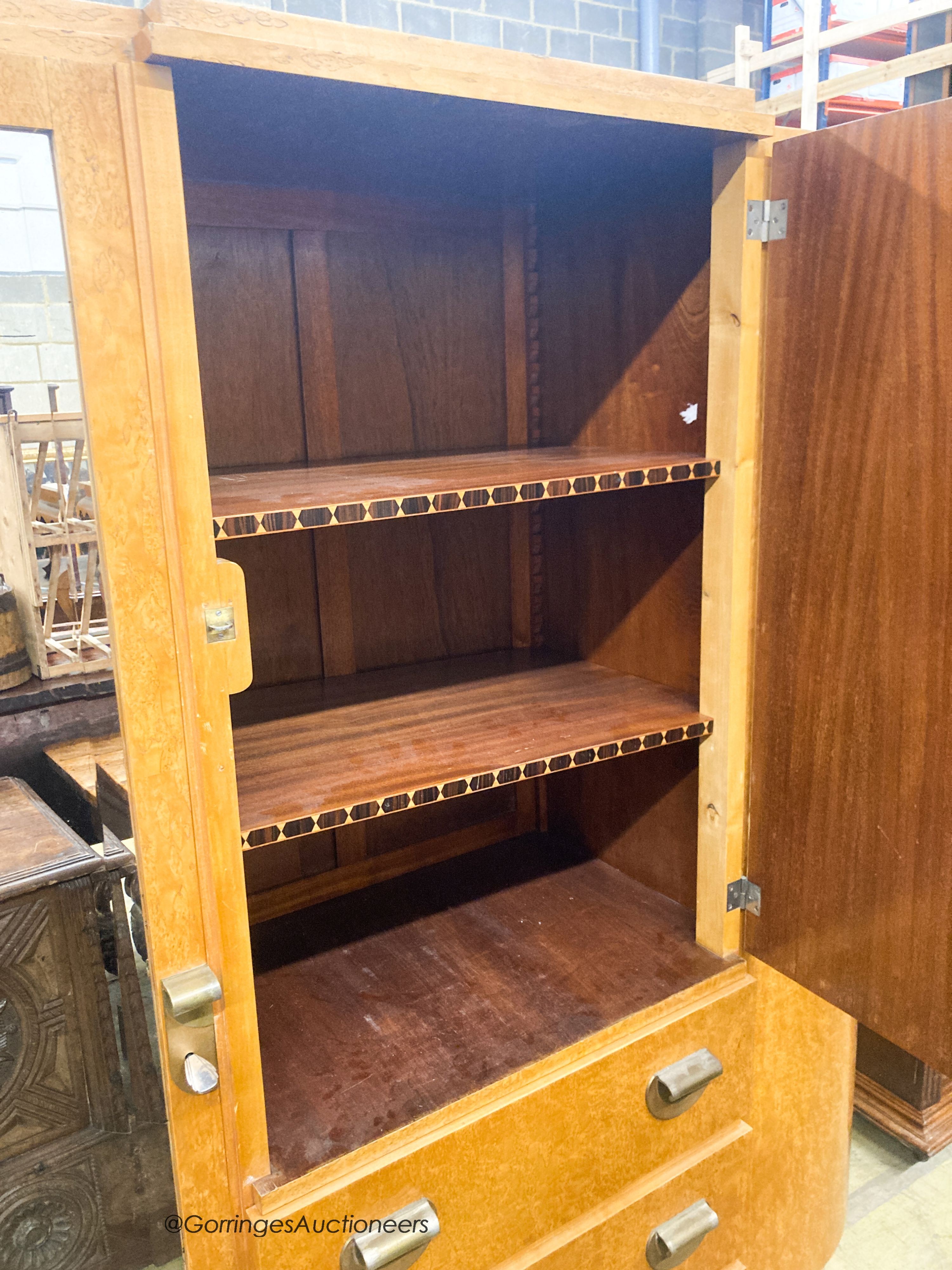 A French Art Deco birds eye maple and mahogany compactum wardrobe, W.174cm D.51cm H.181cm